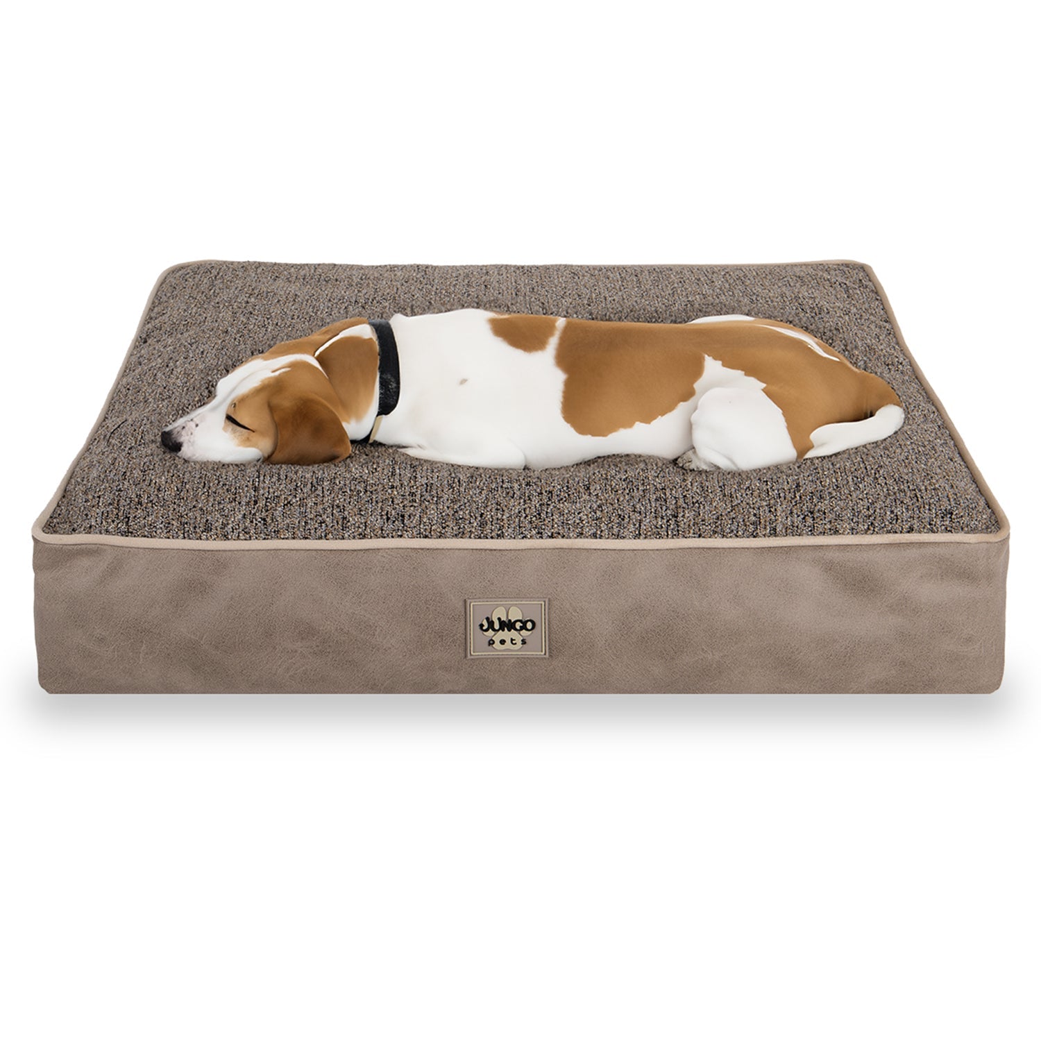 Brown and white dog sleeping on a rectangular orthopedic pet bed with textured cover