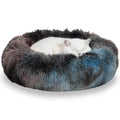 White cat sleeping in a round, fluffy blue and gray pet bed