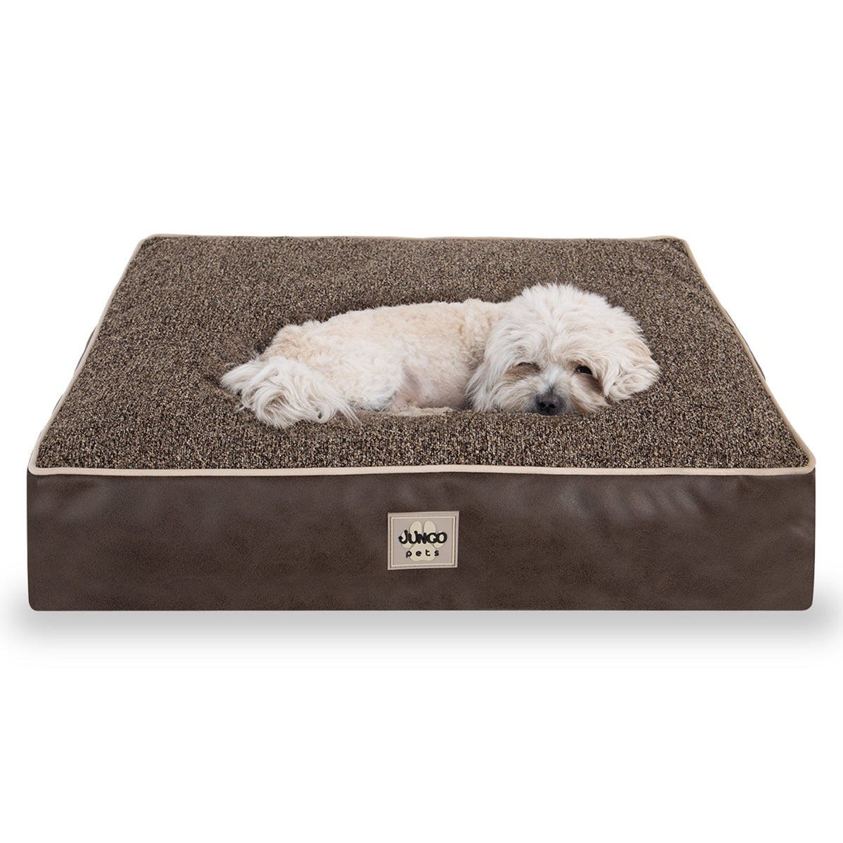 Small white dog resting on a square brown orthopedic pet bed with textured surface