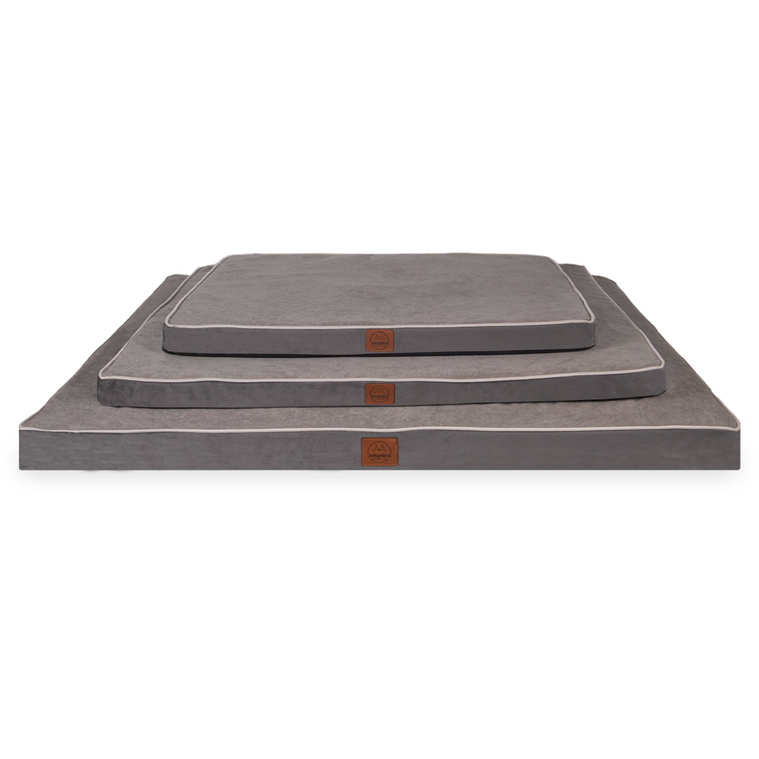 Stacked gray rectangular dog beds in three sizes with white piping and logo patch