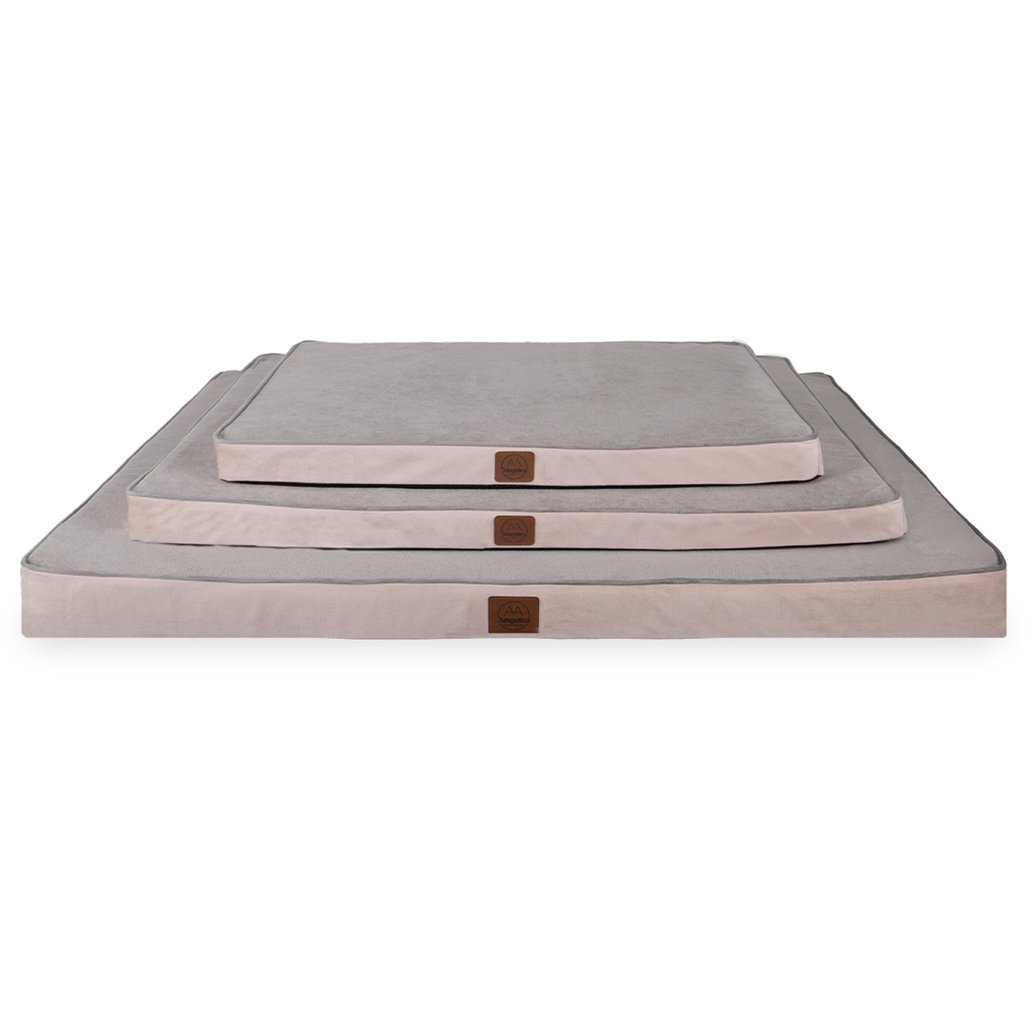 Stack of three square pink and gray textile cushions in varying sizes on white background