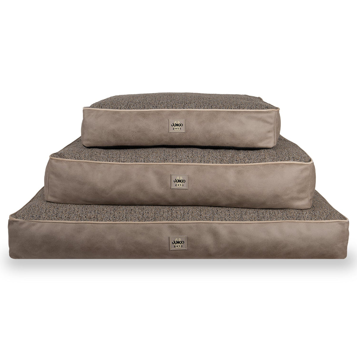 Stack of three rectangular taupe dog beds with textured tops on a white background
