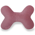 Pink bone-shaped decorative pillow on white background