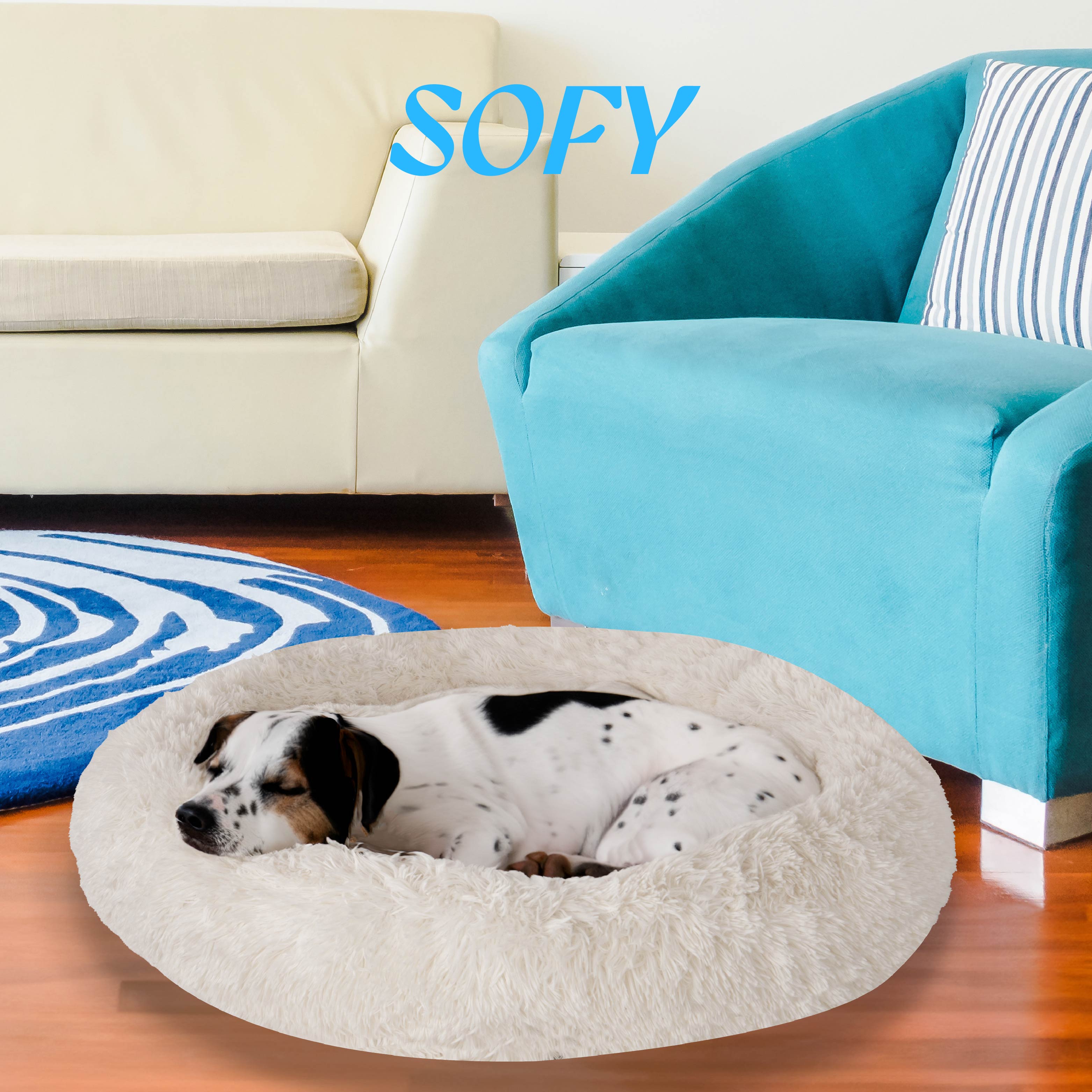 Spotted dog sleeping in fluffy round pet bed in modern living room.