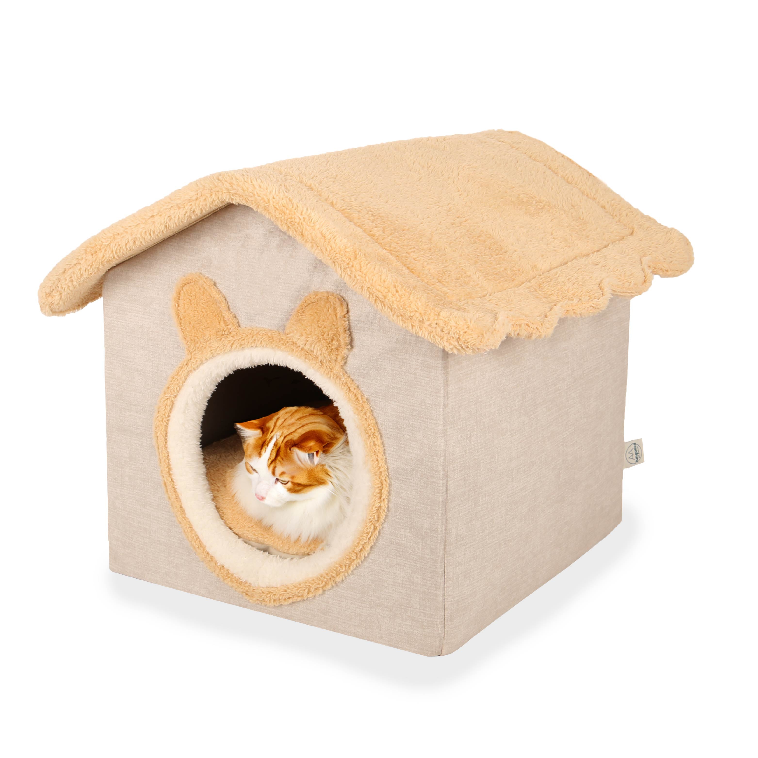 Fluffy cat resting inside beige plush cat house with round entrance and soft roof