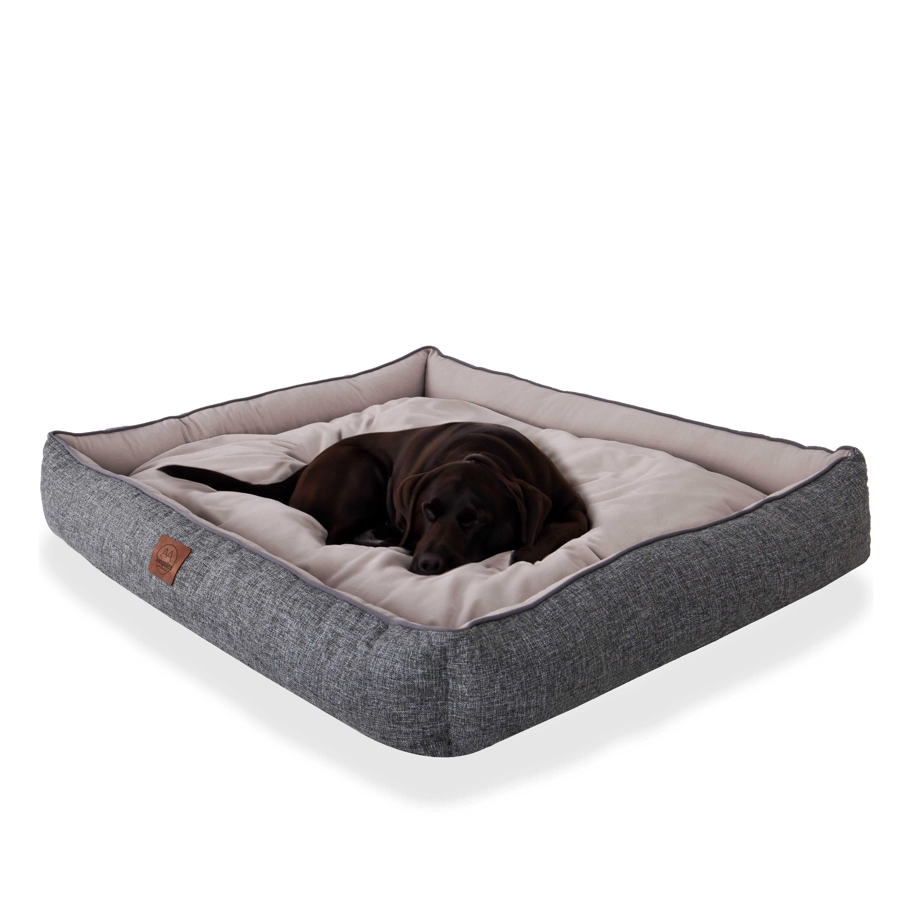 Large black dog resting on a square gray and beige pet bed, comfortable dog cushion
